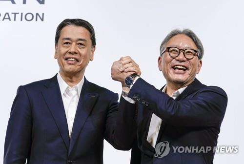(도쿄 EPA=연합뉴스) 우치다 마코토 닛산자동차 사장(왼쪽)과 미베 도시히로 혼다자동차 사장이 지난 8월 1일 일본 도쿄에서 연 공동기자회견에서 손을 잡고 포즈를 취하고 있다. 이날 양사 사장은 혼다와 닛산자동차가 맺은 '동맹'에 미쓰비시 자동차가 합류하기로 했다고 밝혔다. 2024.12.23. / 연합뉴스